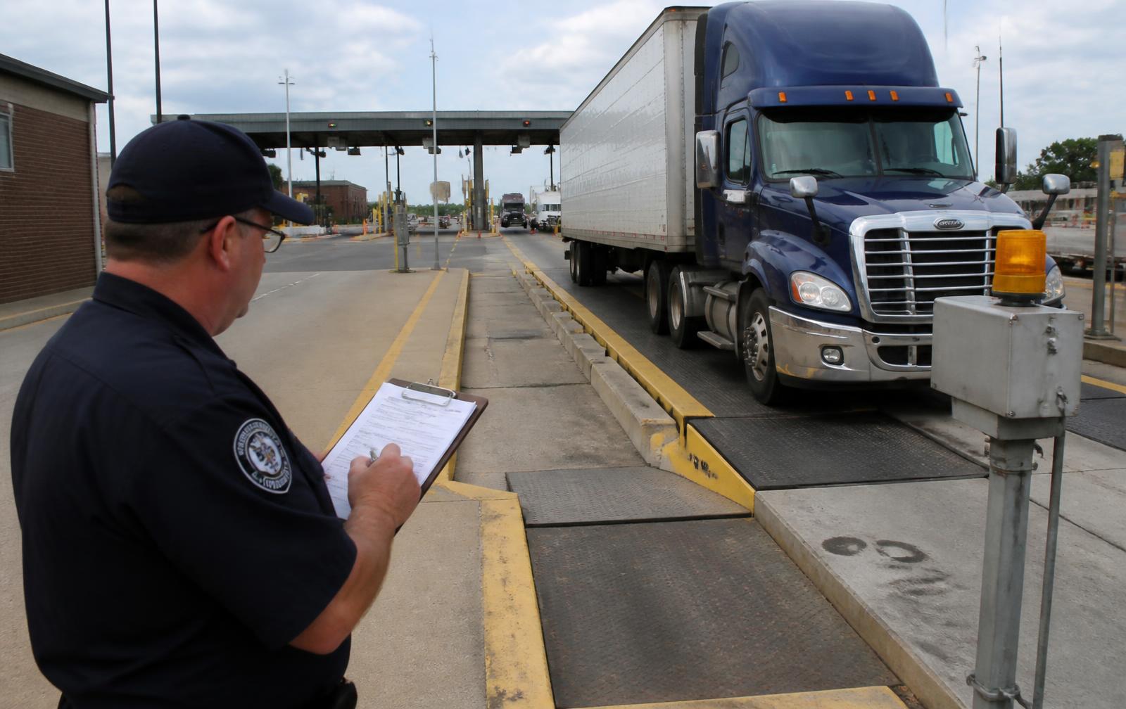 Truck being weighed and inspected at a highway weigh station